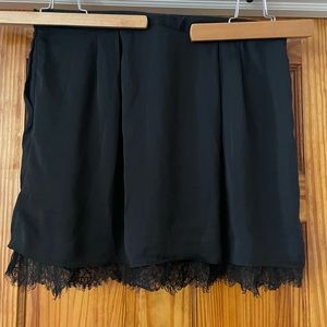 Short black slip skirt with lace hem